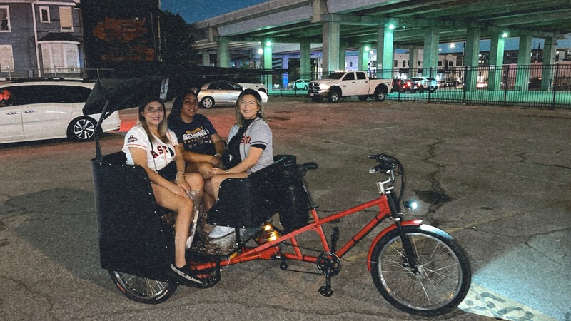 Friends enjoying a City Yacht Tours pedicab ride through Houston