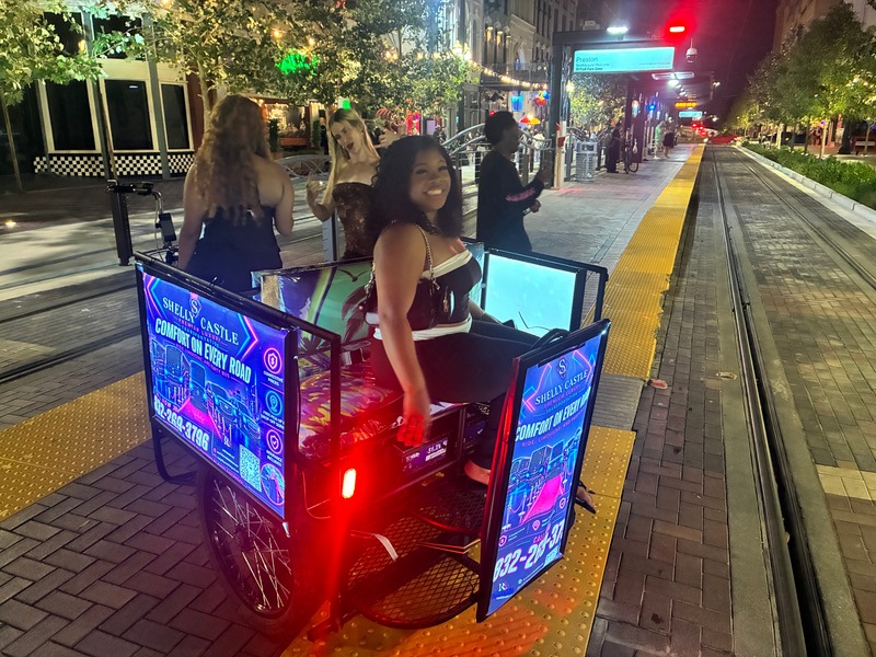 Guests riding through downtown Houston with the Shelly's Castle pedicab advertisement